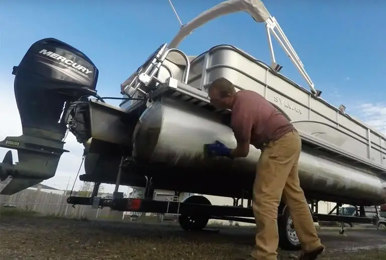 Guy cleaning pontoon boat