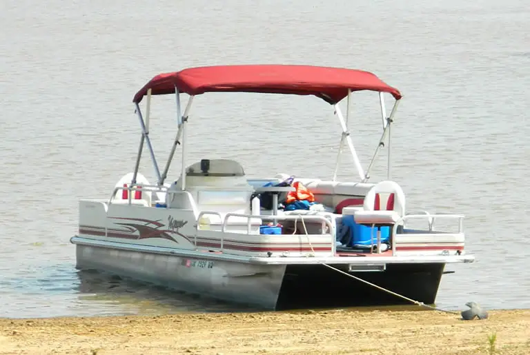 Pontoon boat anchored at beach